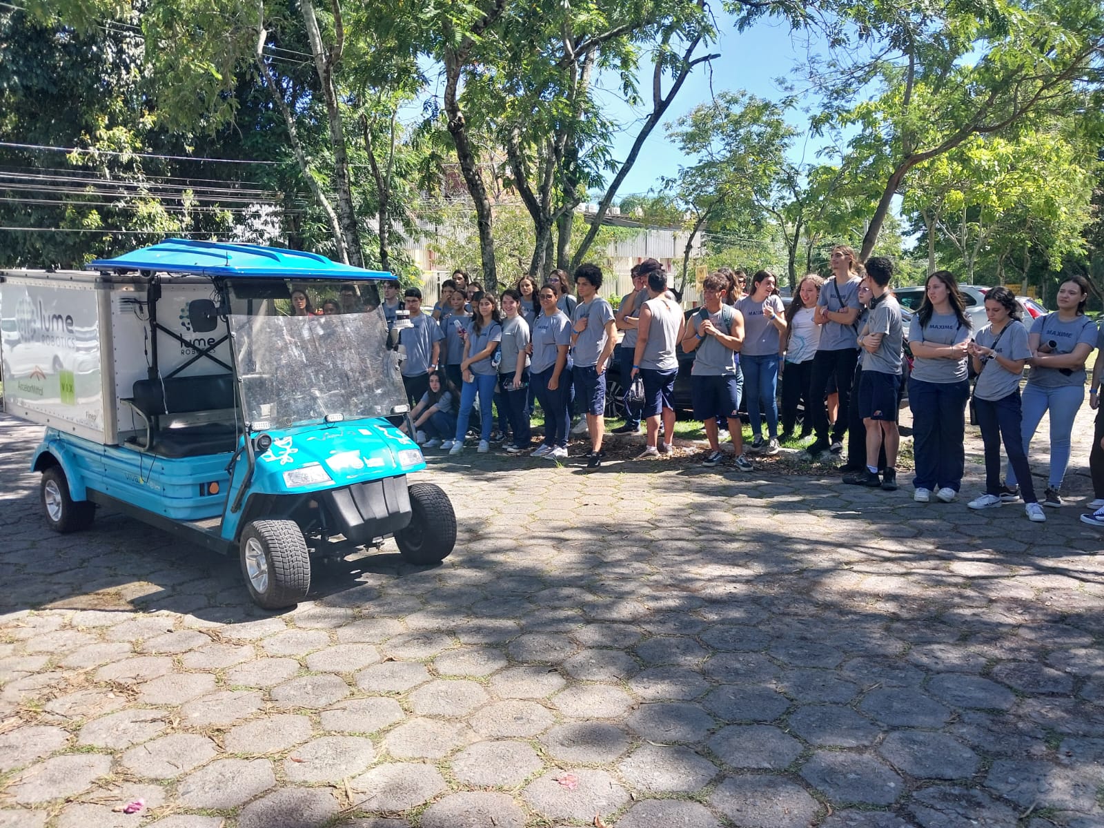 Estudantes conhecendo o carro autônomo Foto dos estudantes conhecendo o carro autônomo