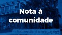Cartaz com a inscrição "Nota à comunidade" e uma foto da reitoria ao fundo, em tons de azul