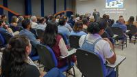 Servidores docentes reunidos no auditório para cerimônia de posse