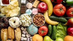 Imagem de uma mesa com diversos alimentos saudáveis ​​e não saudáveis